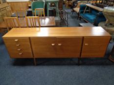 A 20th century teak G Plan triple door sideboard, fitted four drawers, on raised legs, width 199 cm