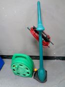 A Hozelock hose pipe on reel together with a Bosch electric strimmer
