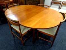 A 20th century White & Newton circular teak extending dining table, length 168 cm, fitted a leaf,