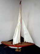 A large wooden model of a pond yacht on stand,