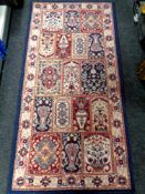 A machine made rug of Persian design 162cm by 81cm