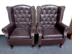 A pair of button vinyl wingback armchairs