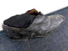 A vintage cobbler's oversized leather shoe advertisement,