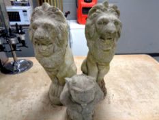 A pair of concrete garden figures, seated lions,