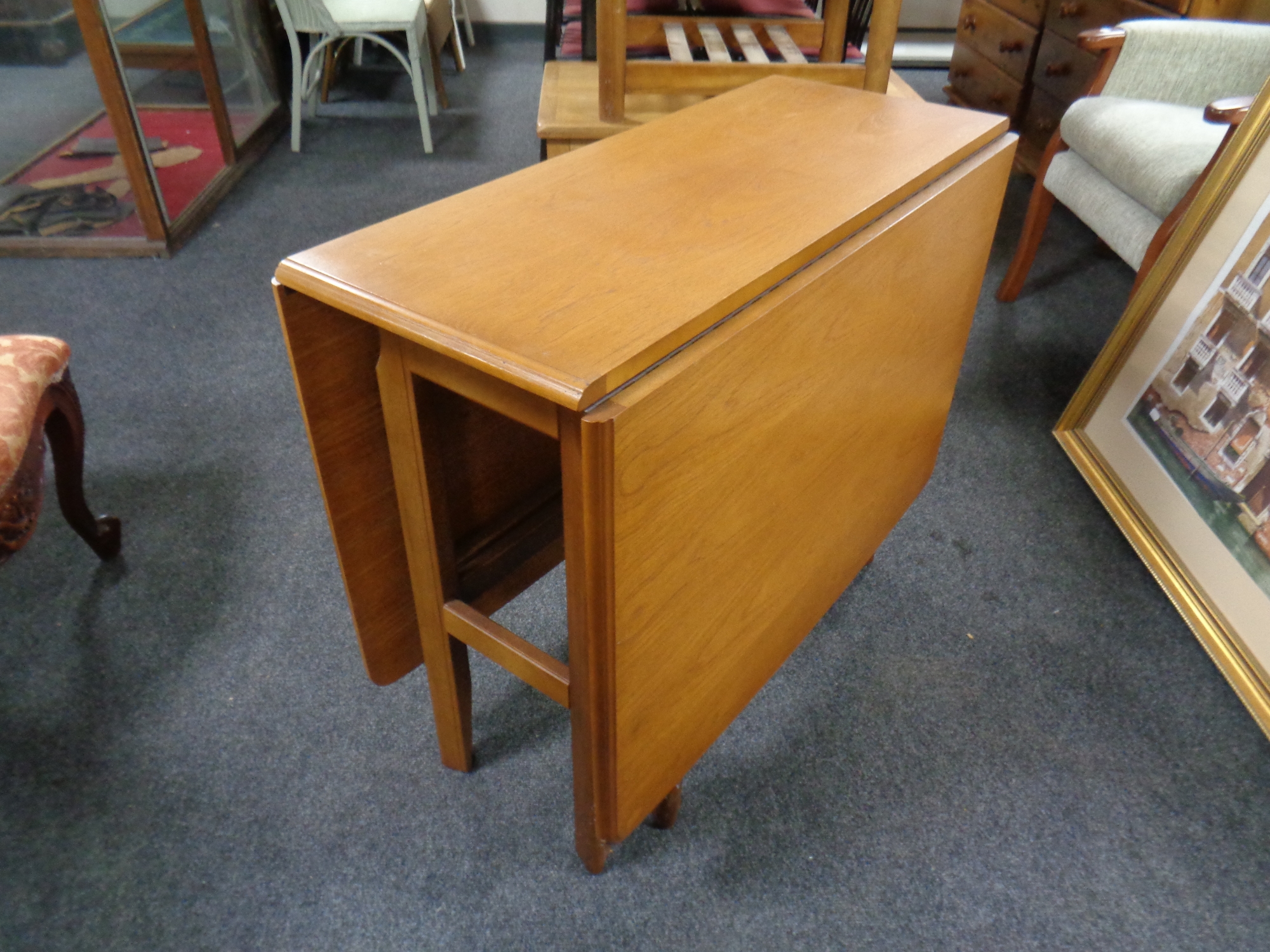 A 20th century Meredew teak drop leaf table