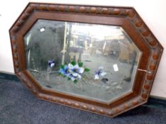 An Edwardian oak octagonal framed mirror with hand painted decoration