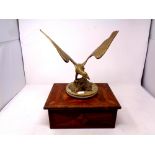 A brass figure of an eagle mounted on a marble base together with an antique marquetry trinket box