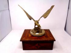 A brass figure of an eagle mounted on a marble base together with an antique marquetry trinket box