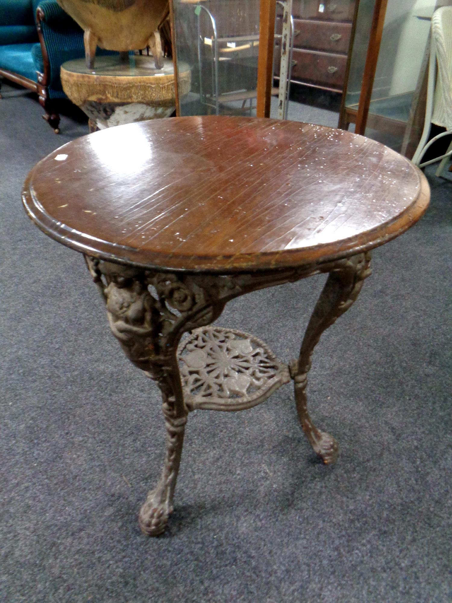 A circular bar table on a cast iron Britannia base,