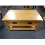A contemporary oak two tier coffee table fitted a drawer,