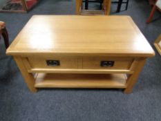 A contemporary oak two tier coffee table fitted a drawer,