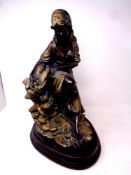 A gilt plaster figure of a fisherwoman,