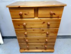 A contemporary pine five drawer chest