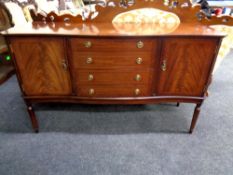 An eleven piece Regency style dining room suite : serpentine fronted sideboard,