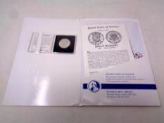 A Franklin Mint John F Kennedy 1964 silver half dollar with certificate in folder together with a