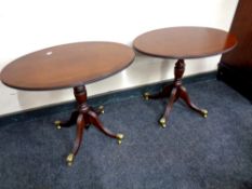 A pair of contemporary mahogany wine tables on brass capped feet