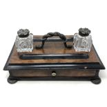 A Victorian walnut and ebonised desk standish with two cut glass inkwells