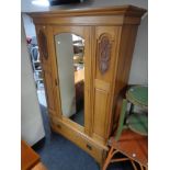 An Edwardian satin wood mirror door wardrobe, fitted a drawer beneath,