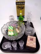 A tray containing assorted glassware, a boxed bottle of Chartreuse,