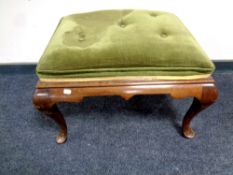 A 19th century mahogany footstool upholstered in a green button dralon