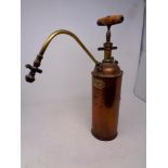 An antique copper and brass pump sprayer