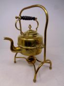 An antique brass spirit kettle on stand with burner