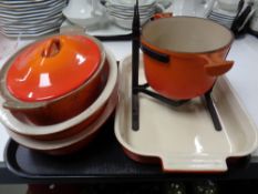 Four ceramic Le Creuset oven dishes, one with cast iron lid,
