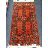 An Afghan style rug on red ground,