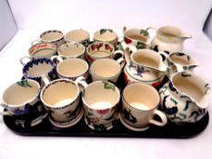 A tray containing a quantity of hand crafted Bridgewater pottery mugs and jugs