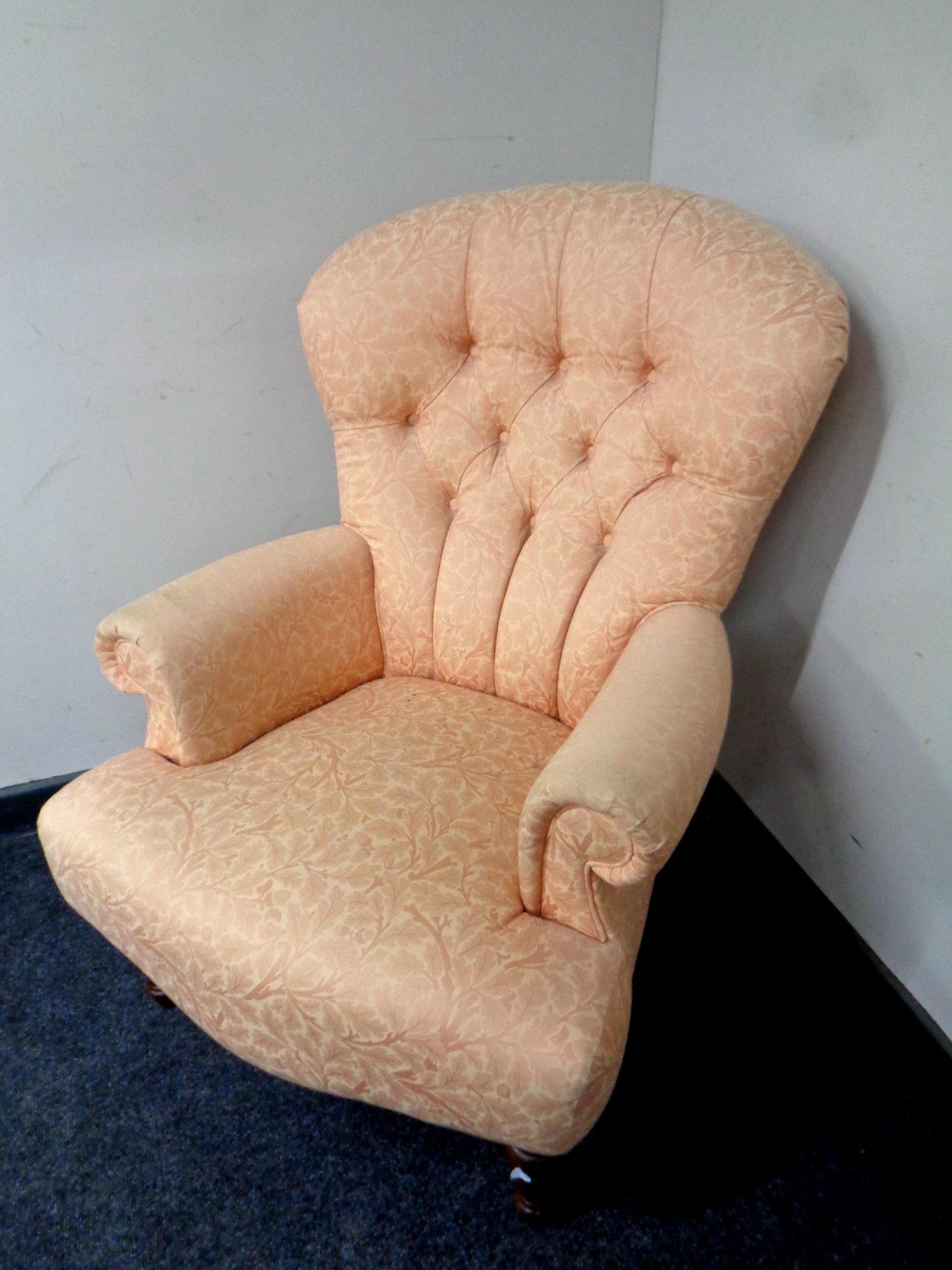 A Victorian style armchair in peach floral fabric