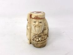 A Japanese carved bone netsuke - Village elder with a basket by his feet.