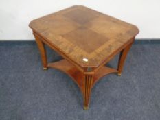 A reproduction French style two tier table in a walnut finish