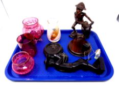 A tray containing oriental carved wooden figures, three pieces of cranberry glassware,