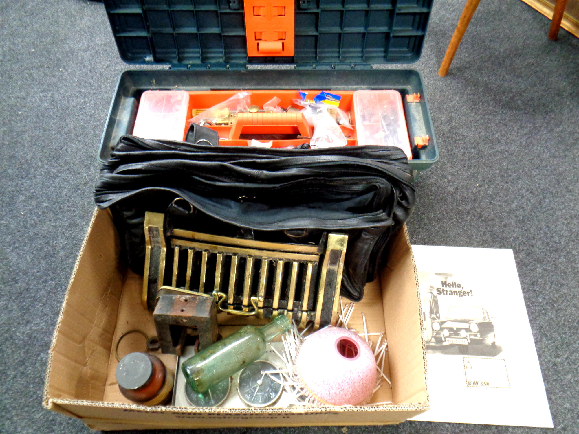A large plastic toolbox containing tools and hardware together with a further box containing