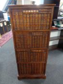 A contemporary faux book fronted four drawer chest