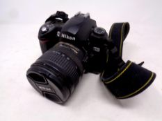 A Nikon D70 camera with lens