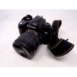 A Nikon D70 camera with lens