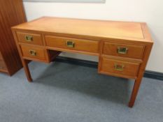 A Chinese style five drawer kneehole desk, width 137 cm,