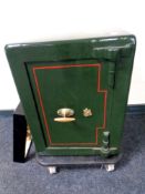 An antique metal safe with keys, fitted internal drawer, height 61 cm, depth 42 cm, width 46 cm,