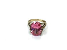 A 9ct yellow gold vibrant pink dress ring, probably synthetic sapphire, size N, 5.2g.