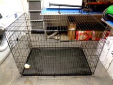 A large folding metal dog cage,
