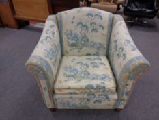 An armchair upholstered in an oriental pattern fabric