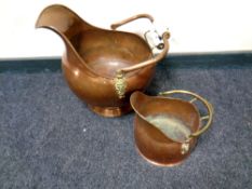A continental brass and copper porcelain handled coal bucket together with a further coal bucket