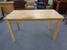 A contemporary oak office table fitted three drawers,