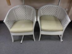 A pair of plastic garden armchairs