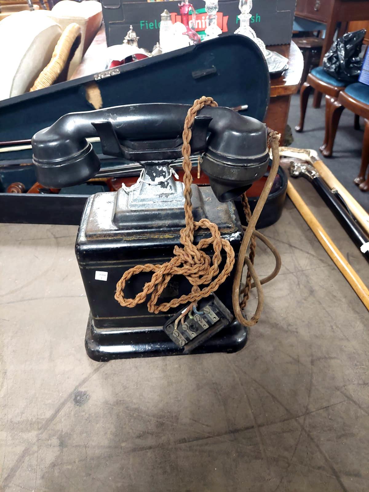 An antique black Bakelite telephone
