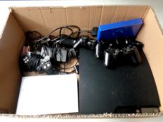 A box containing Play Station II and Play Station III with leads and controllers