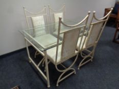 A contemporary wrought iron glass topped dining table together with a set of four matching chairs