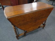 An Edwardian oak barley twist gate leg table