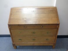 A 19th century oak fall front bureau fitted three drawers beneath,